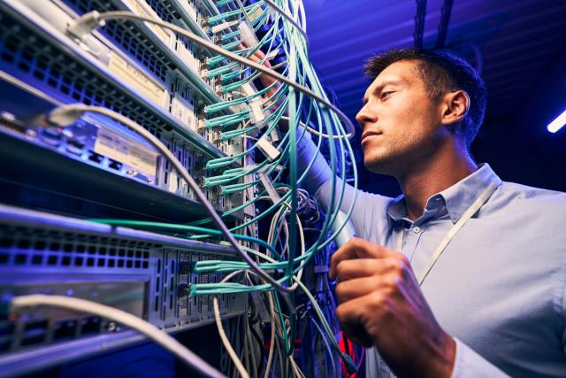 A person connecting IT equipment